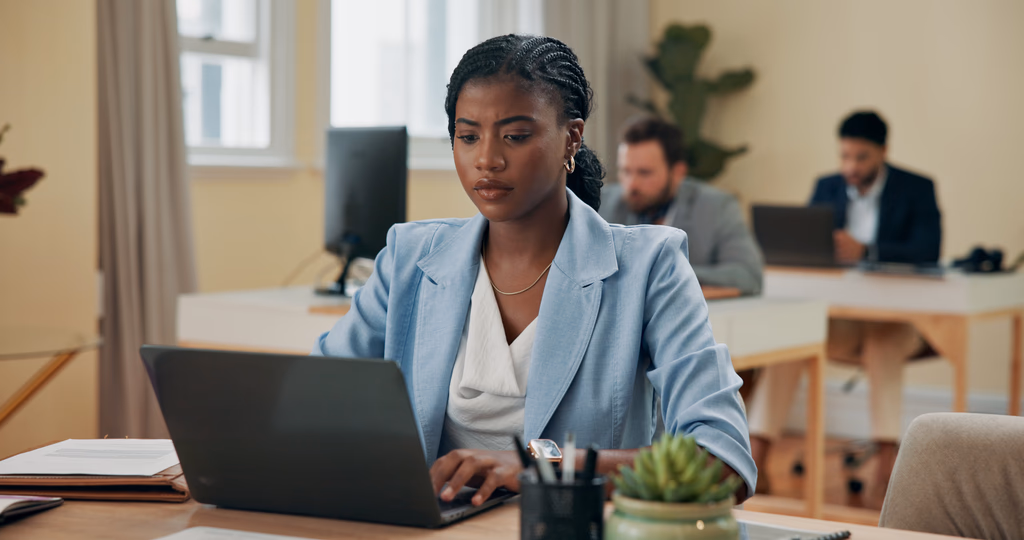 HR professional working on a laptop in an office